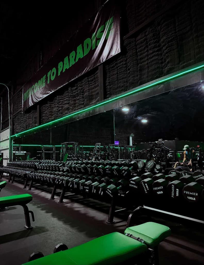 Premier dumbbell rack along the mirror wall at Paradise Gym