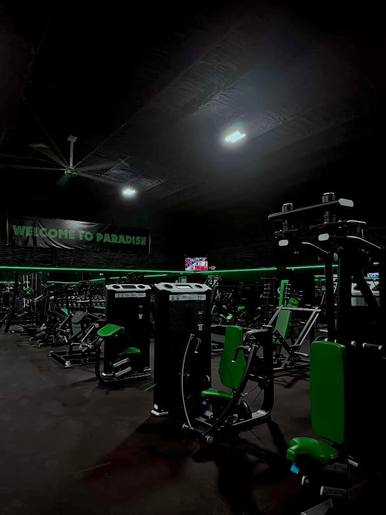Strength machines and Welcome to Paradise banner on the training floor